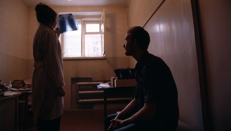 A nurse reviews the chest x-ray of an imprisoned man, in Siberia, Russia, in 1999. Photo credit: © Antoine Gyori/Sygma/Getty A nurse holding a x-ray up to a window