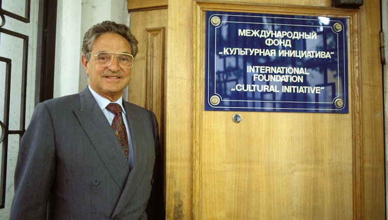 George Soros at the offices of the International Foundation Culture Initiative, in Moscow, Russia, on May 26, 1993. Photo credit: © Simon/Gamma-Rapho/Getty George Soros opening an office door