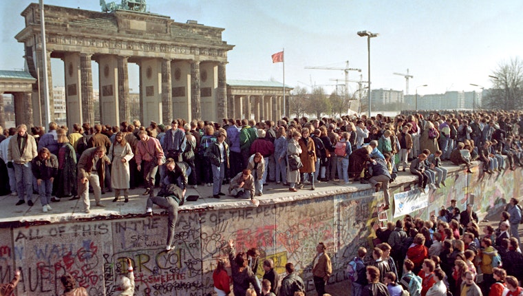 Crowds gather to watch the destruction of the Berlin Wall, in Berlin, Germany, on November 11, 1989. Photo credit: © Kaiser/Caro/Newscom Crowds of people on and around the Berlin Wall