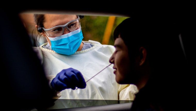 A boy is tested for COVID-19 at a health center serving members of tribal nations of the Great Plains in Rapid City, South Dakota, on June 20, 2020. Photo credit: © Arlo Iron Cloud for the Great Plains Tribal Chairmen’s Health Board A boy is tested COVID-19 with a nasal swab