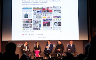 A panel at an investigative journalism conference in London discuss a social media post by Eliot Higgins showing newspaper coverage of a Bellingcat investigation on May 9, 2023. Photo credit: © James Whatling for Truth Tellers/POLARIS/Newscom Five people seated on stage speaking below a projection of news stories