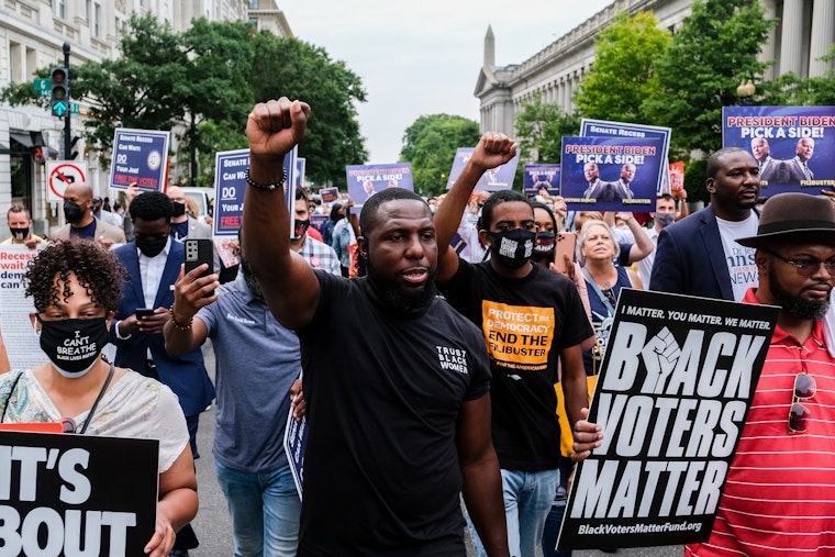 People rally for voting rights in Washington, D.C., on August 4, 2021.
© Michael A. McCoy/Redux A group of protestors marching in the street
