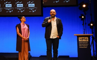 Orwa Nyrabia on stage at the IDFA awards in Amsterdam on November 25, 2021. Photo credit: © idfa/Coen Dijkstra Orwa Nyrabia and a woman standing on a stage