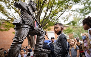 Children attend the unveiling and dedication of a statue honoring Black soldiers in Franklin, Tennessee, on October 23, 2021. Photo credit: © Sarahbeth Maney/NYTimes/Redux A child stands in front of a statue honoring Black soldiers.